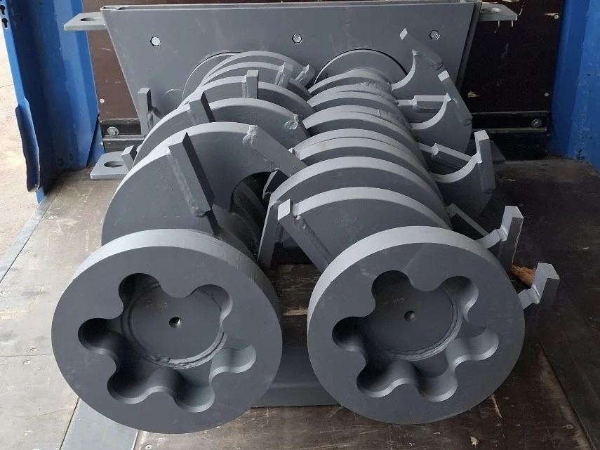 Heavy-duty Arjes Impaktor 250 full rod shredder shafts with Hardox 500 knife blocks, ready for shipping in a truck bed.