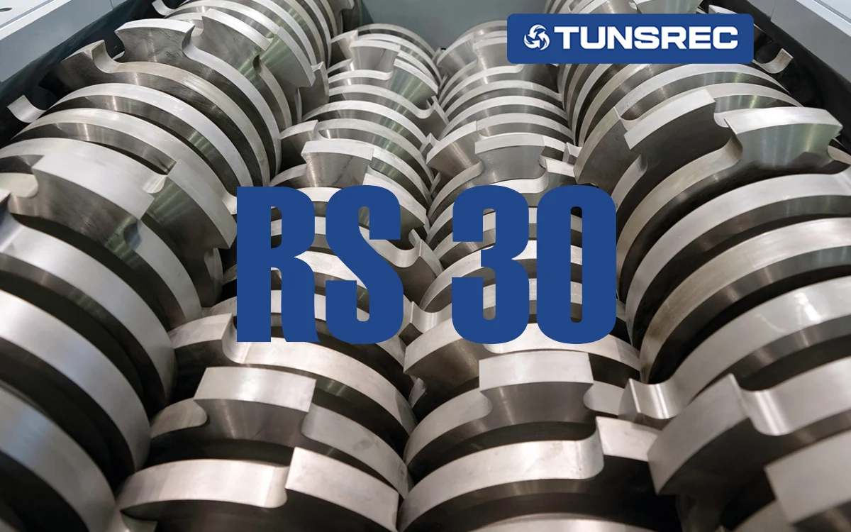 Close-up of industrial shredder knives and cutters, showcasing robust, intermeshed metallic blades designed for heavy-duty material reduction in an UNTHA RS30 four-shaft shredder.