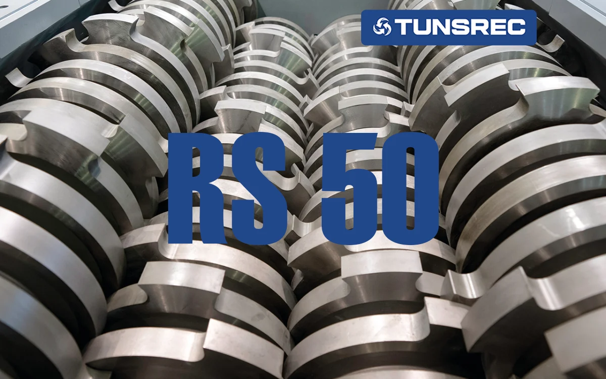 Close-up of industrial shredder knives and cutters, showcasing robust, intermeshed metallic blades designed for heavy-duty material reduction in an UNTHA RS50 four-shaft shredder.