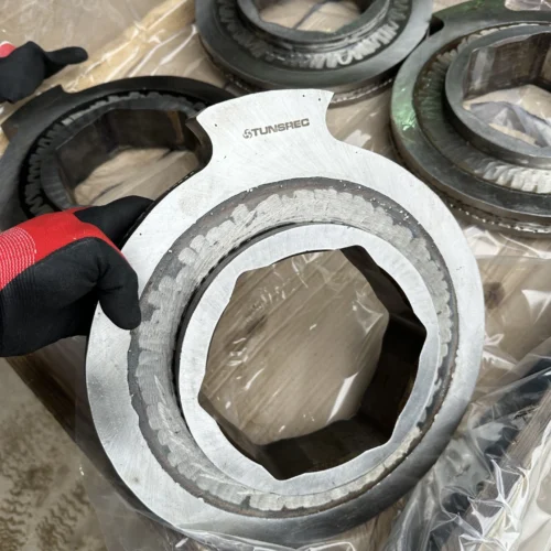 Close-up of a refurbished cutter disc showing the hexagonal mounting hole and the STUNSREC brand engraving.