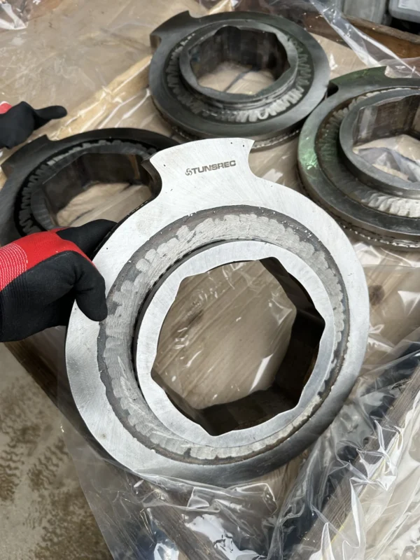 Close-up of a refurbished cutter disc showing the hexagonal mounting hole and the STUNSREC brand engraving.