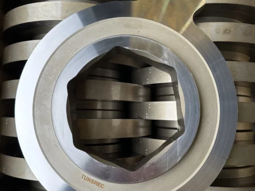 Multiple high-grade metallic cutter units for UNTHA RS 30, 40, 50, 60, 100, 150 shredders, neatly stacked in a workshop setting.