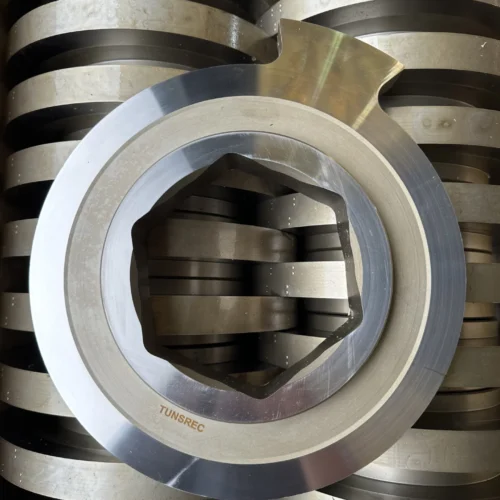 Multiple high-grade metallic cutter units for UNTHA RS 30, 40, 50, 60, 100, 150 shredders, neatly stacked in a workshop setting.