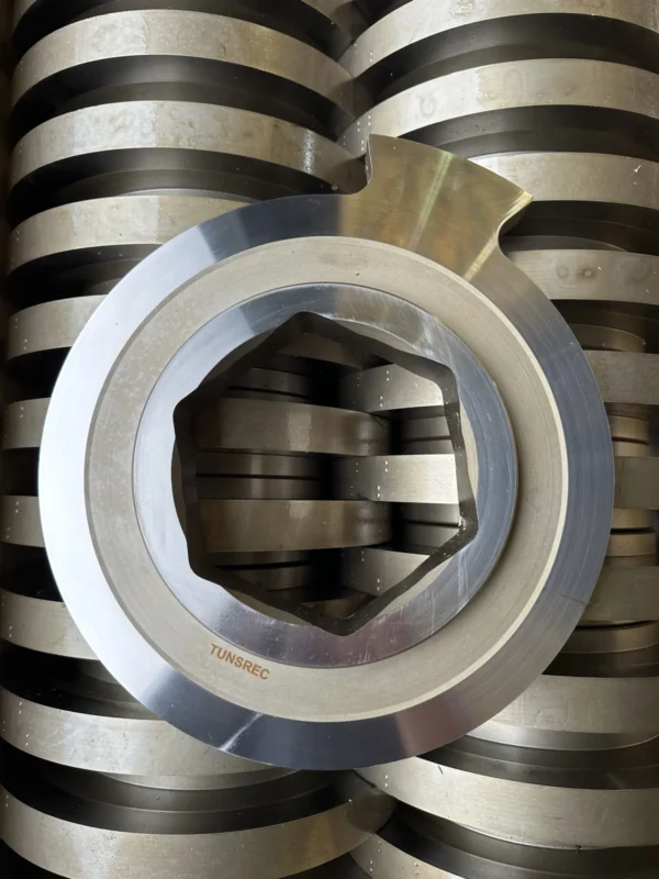 Multiple high-grade metallic cutter units for UNTHA RS 30, 40, 50, 60, 100, 150 shredders, neatly stacked in a workshop setting.